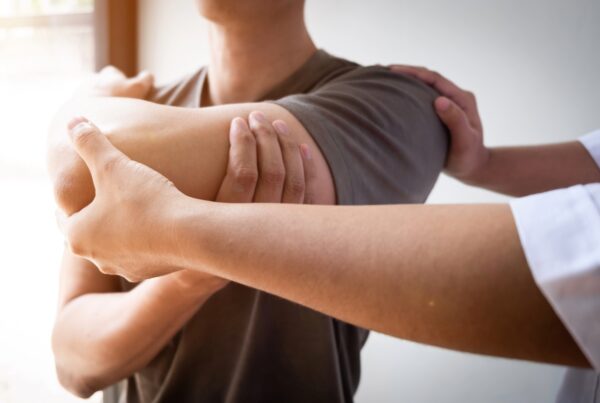 A close-up of a person's hands held together, with visible fingers and wrists, indoors.